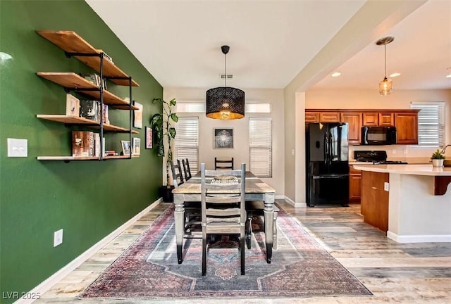 dining space with light wood-type flooring