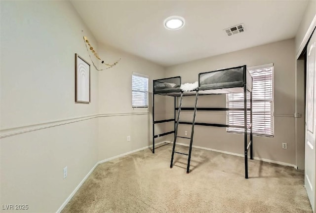 unfurnished bedroom featuring light colored carpet