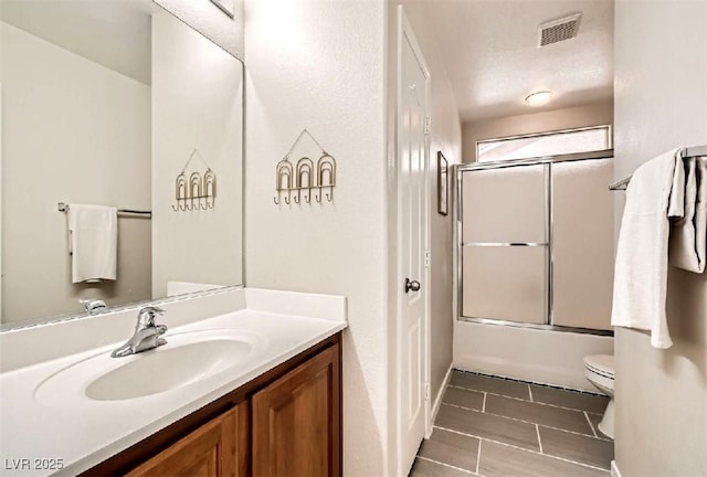 full bathroom with vanity, toilet, tile patterned flooring, and combined bath / shower with glass door