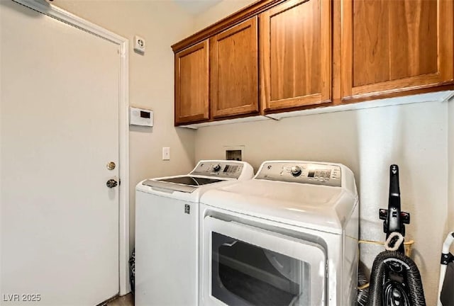 washroom with cabinets and washer and dryer