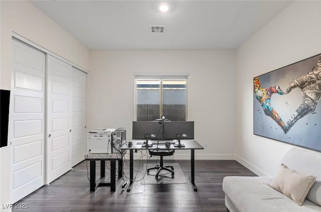 office featuring visible vents, baseboards, and wood finished floors