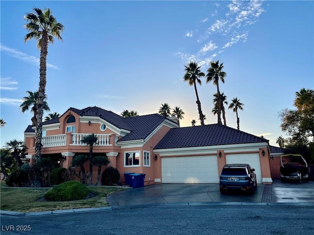 view of front of house featuring a garage and a balcony