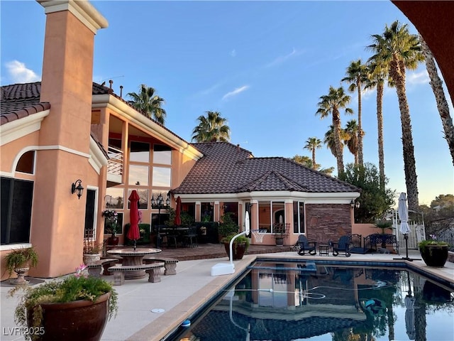 view of pool with an outbuilding and a patio area