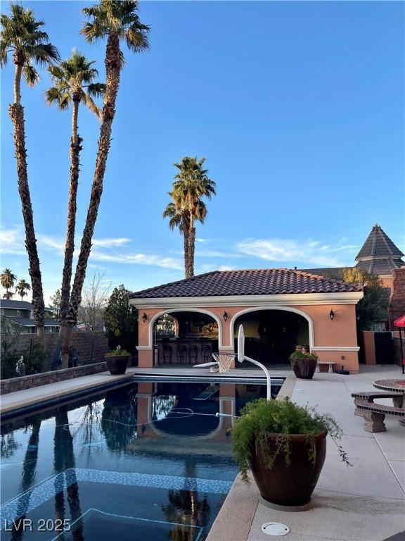 view of pool featuring a patio and exterior bar