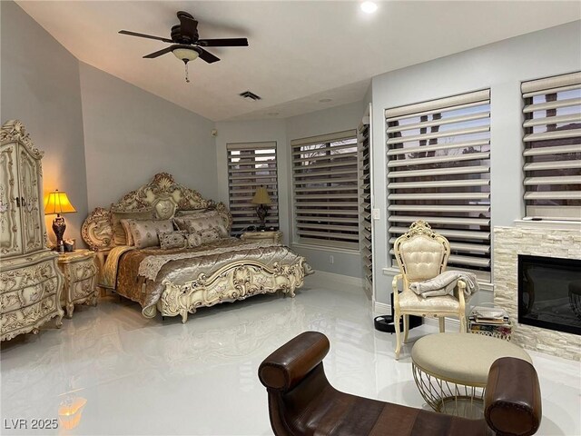 bedroom with vaulted ceiling and a fireplace