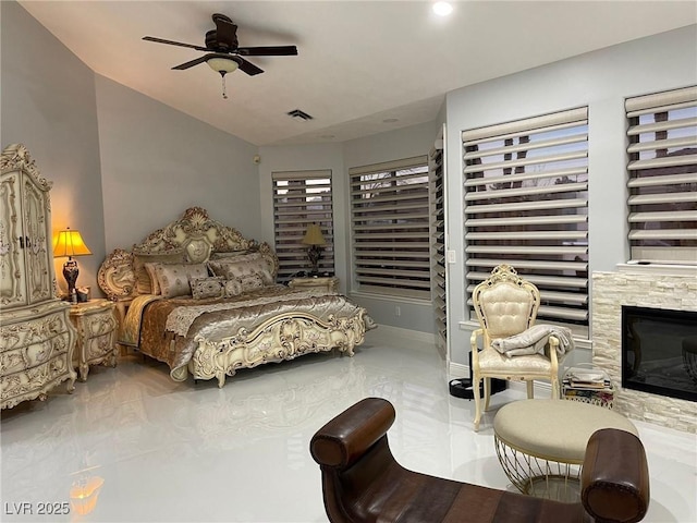 bedroom featuring lofted ceiling, marble finish floor, a fireplace, and visible vents