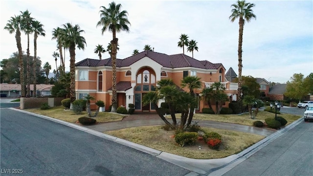 view of front of home with a tile roof and stucco siding