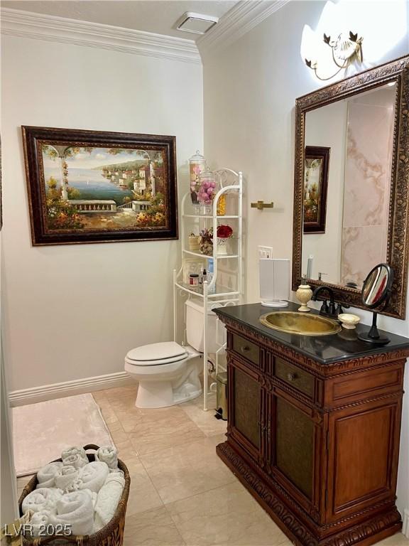 bathroom with visible vents, baseboards, toilet, ornamental molding, and vanity