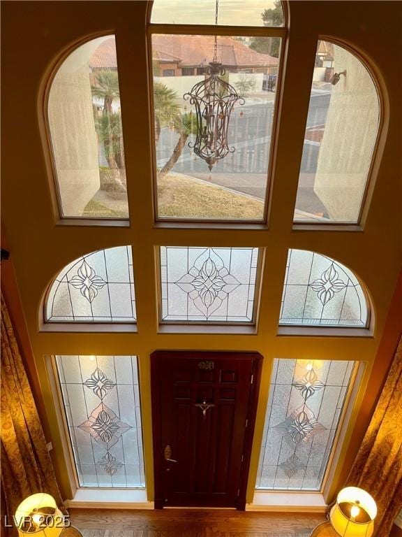 entryway with a towering ceiling and a chandelier