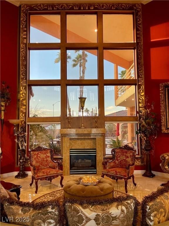 sitting room featuring expansive windows and a premium fireplace