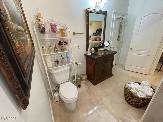 bathroom featuring marble finish floor, vanity, and toilet