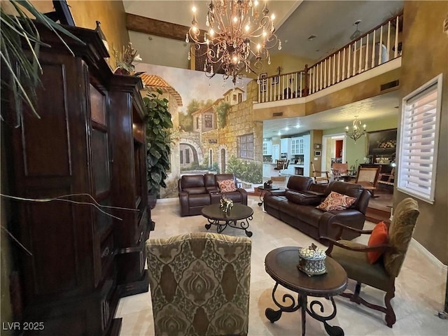 living area featuring baseboards, a high ceiling, a chandelier, and visible vents