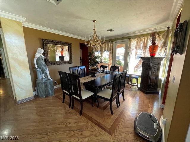 dining room featuring baseboards, visible vents, ornamental molding, a textured ceiling, and a chandelier