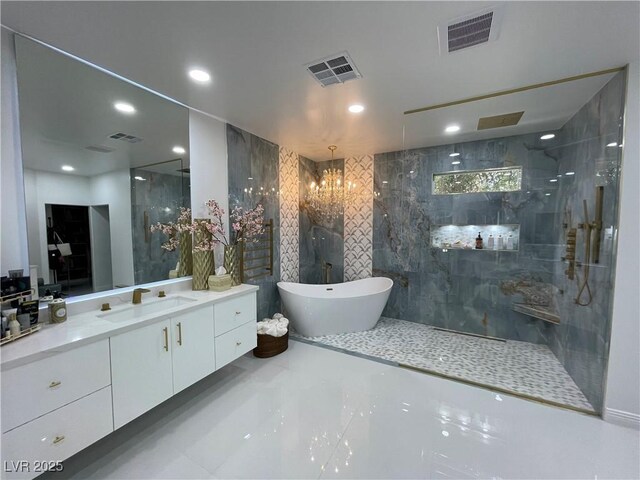 bathroom with visible vents, vanity, and walk in shower