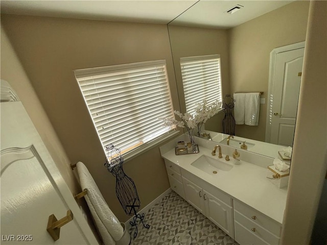 bathroom with visible vents, vanity, and baseboards