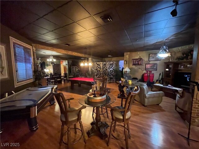 game room with a chandelier, a drop ceiling, billiards, and wood finished floors