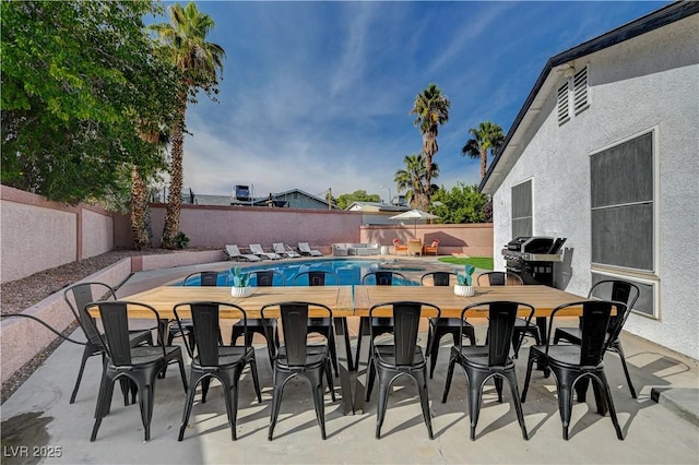 view of pool with a grill and a patio area