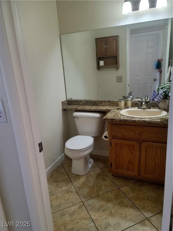 bathroom featuring vanity, tile patterned flooring, and toilet