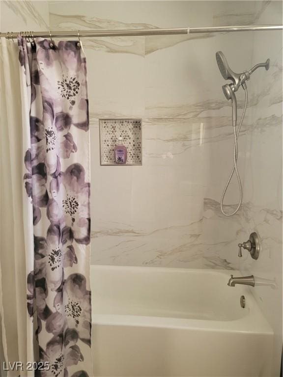 bathroom with shower / bath combo with shower curtain