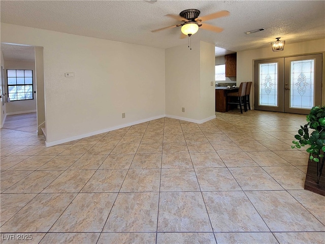 unfurnished living room featuring light tile patterned flooring and a wealth of natural light