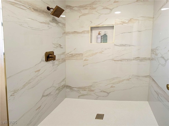 bathroom with a tile shower