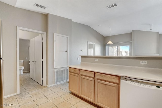 kitchen with light tile patterned flooring, light brown cabinetry, decorative light fixtures, dishwasher, and lofted ceiling