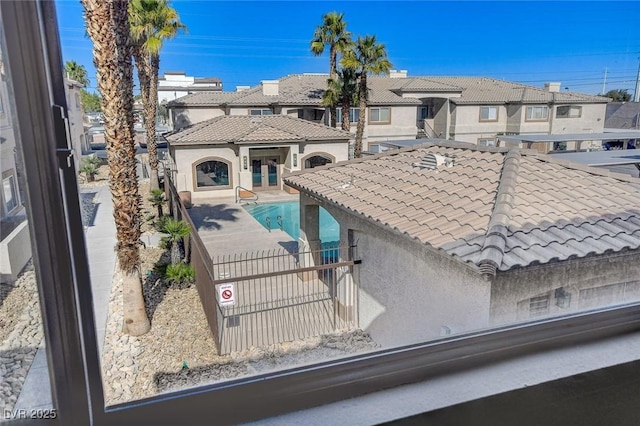 exterior space with a fenced in pool and a patio area