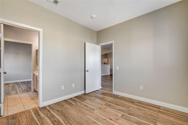 unfurnished bedroom featuring light wood-type flooring