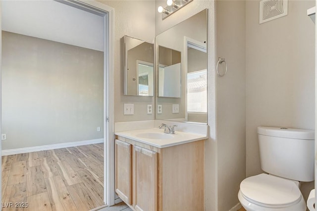 bathroom featuring hardwood / wood-style flooring, vanity, and toilet