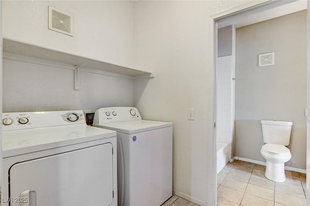 laundry room with light tile patterned floors and washer and dryer