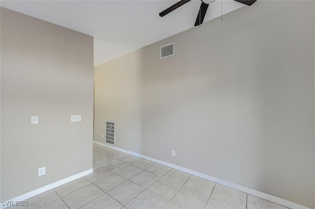 tiled spare room with ceiling fan