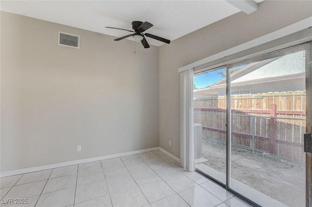 tiled spare room with ceiling fan