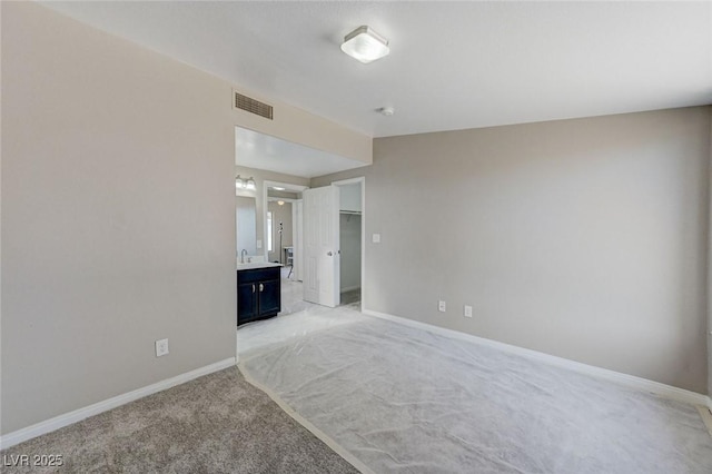 spare room with light carpet and sink