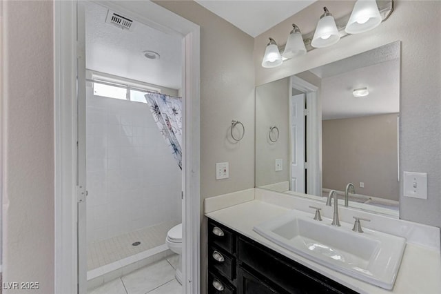 bathroom featuring vanity, curtained shower, tile patterned floors, and toilet