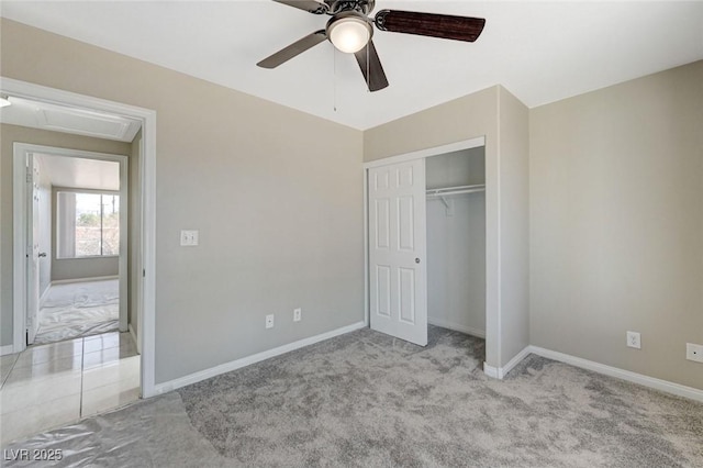 unfurnished bedroom featuring light colored carpet, a closet, and ceiling fan