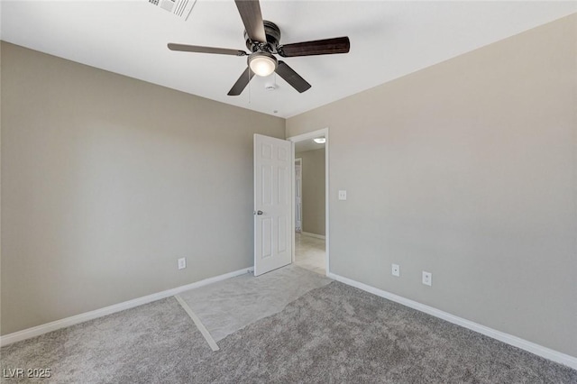 carpeted spare room with ceiling fan