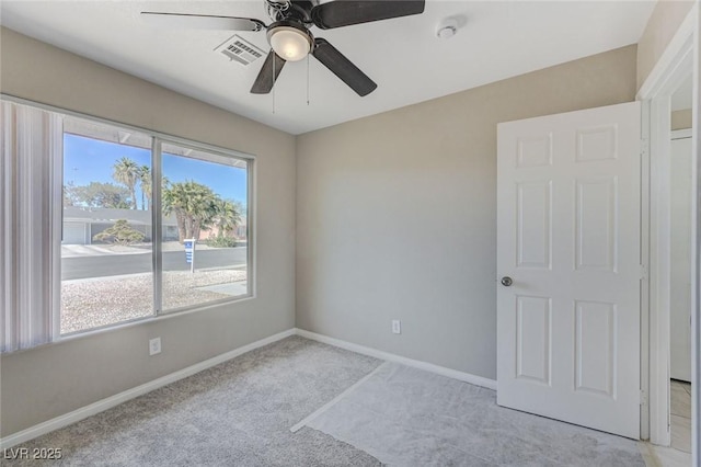 unfurnished room with ceiling fan and light colored carpet