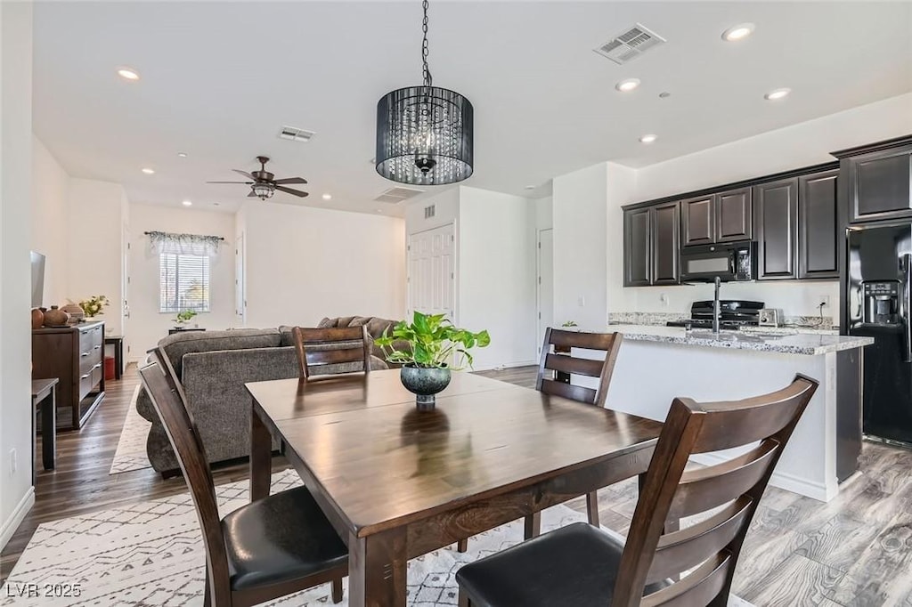 216 Copland Canyon Ave, Henderson, NV 89011 - dining area featuring ceiling fan with notable chandelier and light hardwood / wood-style flooring