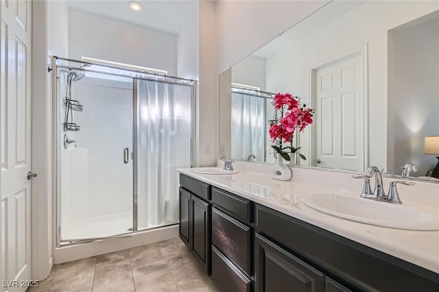 bathroom with vanity, a shower with shower door, and tile patterned floors