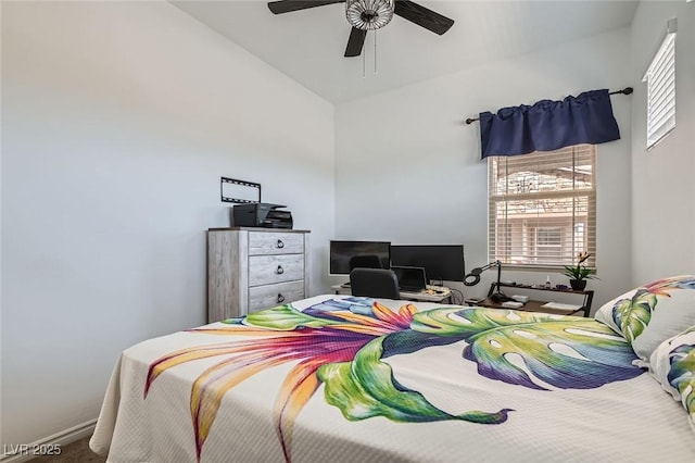 carpeted bedroom featuring ceiling fan and high vaulted ceiling