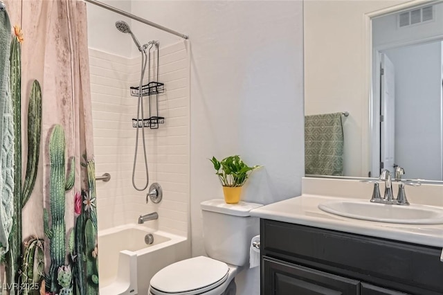 full bathroom with tiled shower / bath, vanity, and toilet