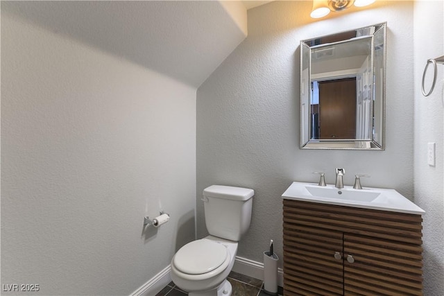 bathroom with vanity, toilet, and tile patterned flooring