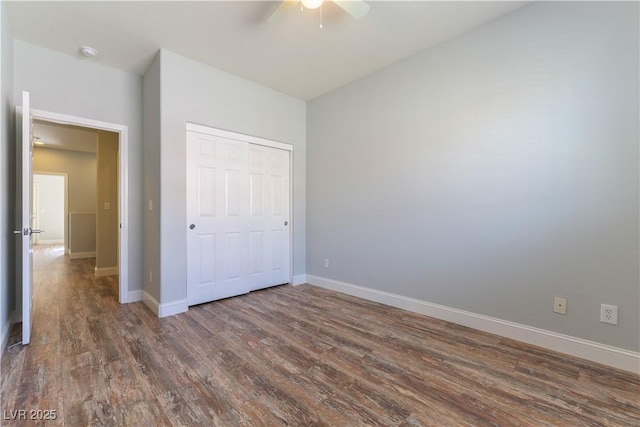 unfurnished bedroom with ceiling fan, dark hardwood / wood-style flooring, and a closet