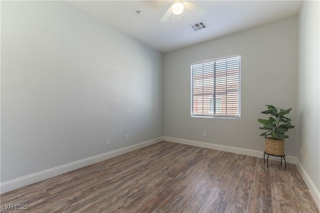 spare room featuring dark hardwood / wood-style floors and ceiling fan