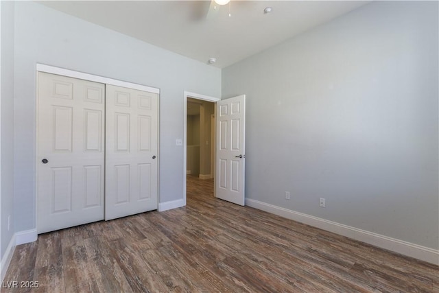 unfurnished bedroom featuring a closet, dark hardwood / wood-style floors, and ceiling fan