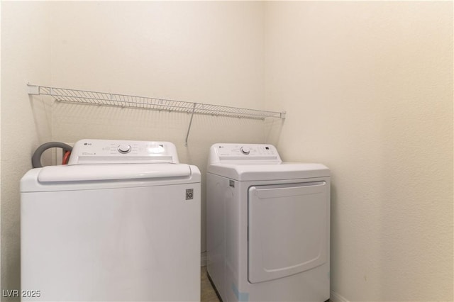 clothes washing area featuring independent washer and dryer