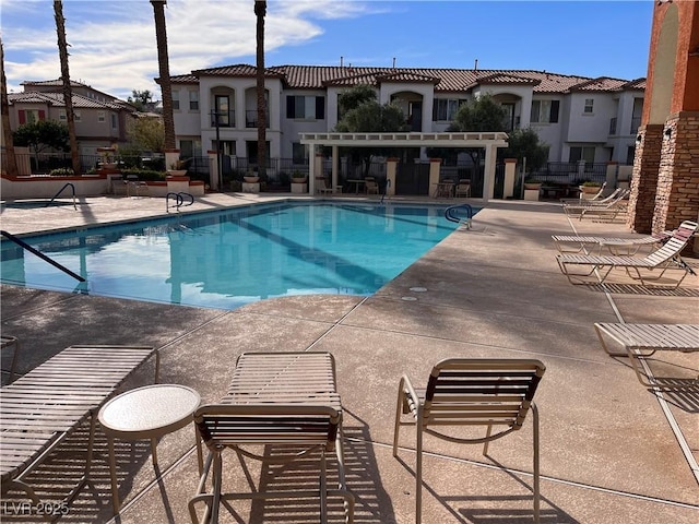 view of swimming pool featuring a patio and a pergola