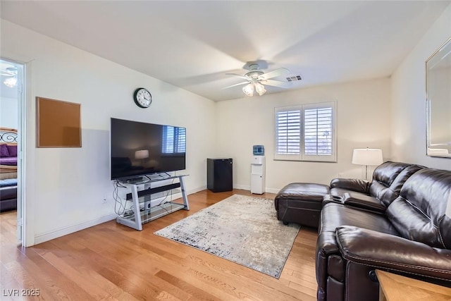 living room with ceiling fan and light hardwood / wood-style floors