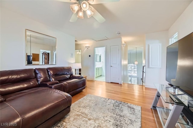 living room with ceiling fan and light wood-type flooring