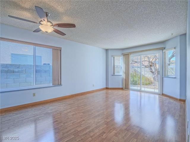 spare room featuring wood-type flooring, ceiling fan, and a textured ceiling